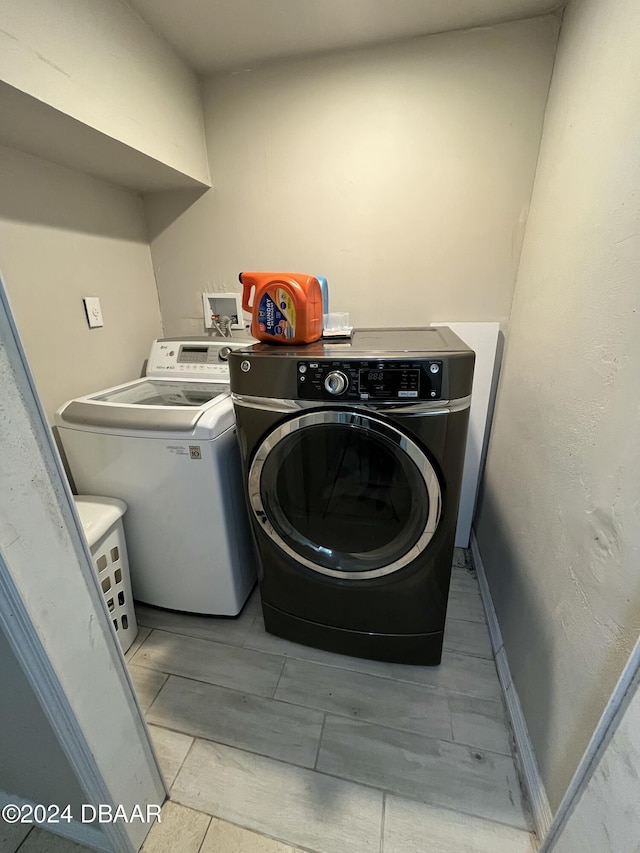 washroom featuring independent washer and dryer