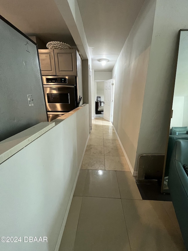 hall featuring light tile patterned flooring