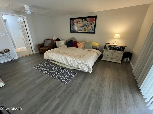 bedroom with connected bathroom, ceiling fan, and hardwood / wood-style flooring