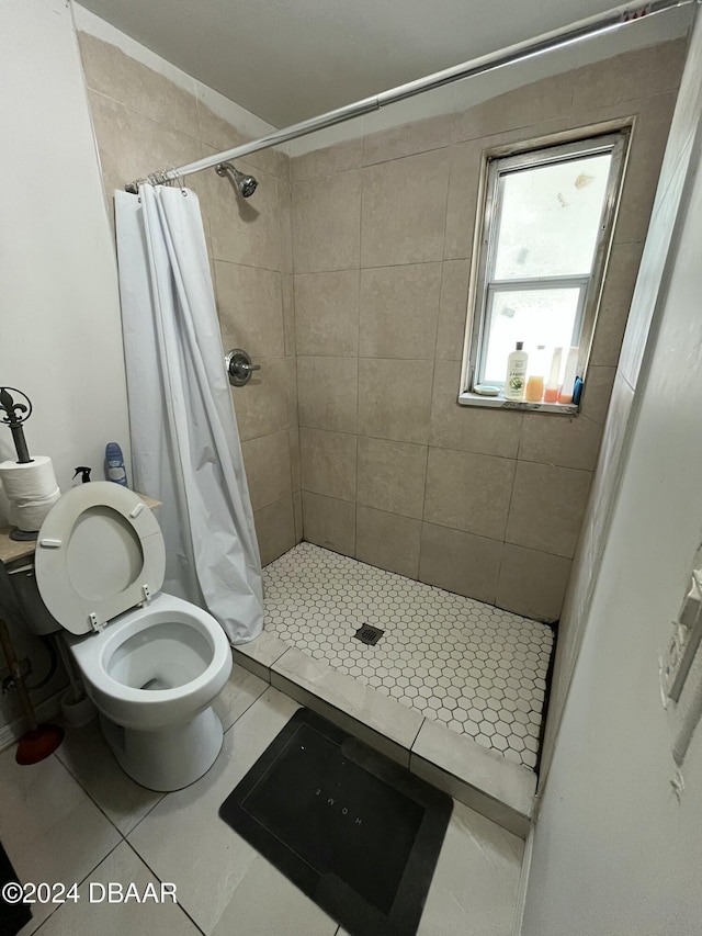 bathroom featuring toilet, tile patterned flooring, and a shower with shower curtain