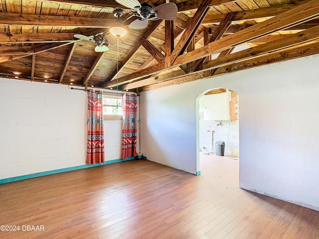 unfurnished room featuring wood ceiling, arched walkways, wood finished floors, and a ceiling fan