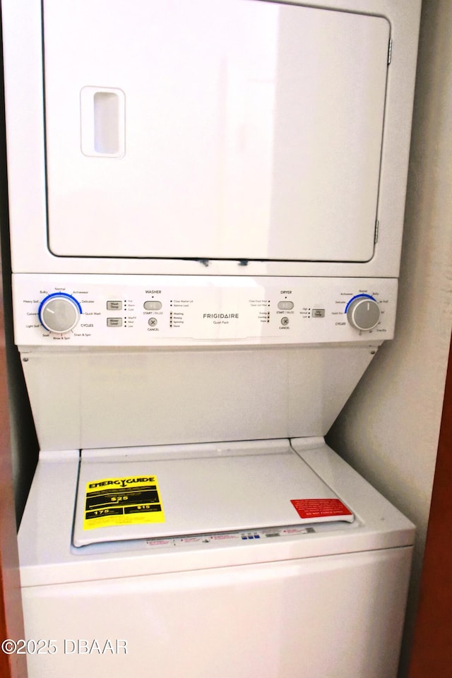 laundry room with stacked washer and dryer and laundry area