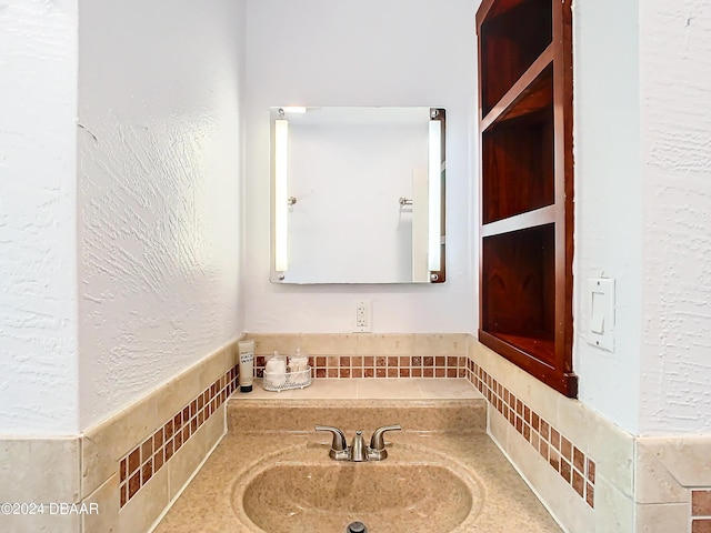 bathroom with a sink and a textured wall