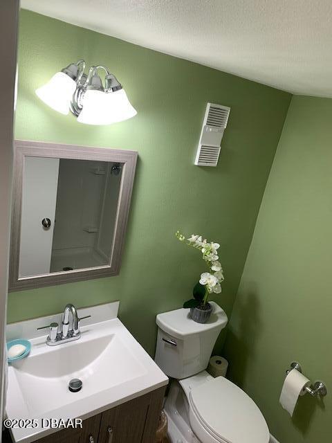 325 Causeway Cswy N Unit D104, New Smyrna Beach, FL 32169 - half bath featuring toilet, vanity, and visible vents