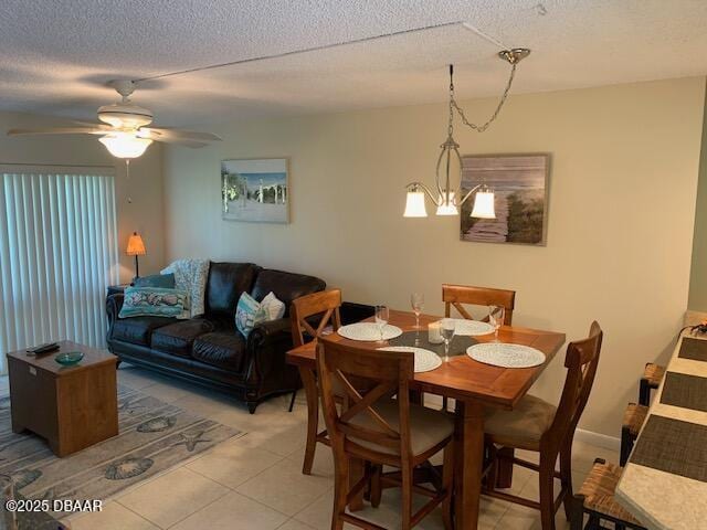 325 Causeway Cswy N Unit D104, New Smyrna Beach, FL 32169 - dining space featuring a ceiling fan, light tile patterned floors, and a textured ceiling