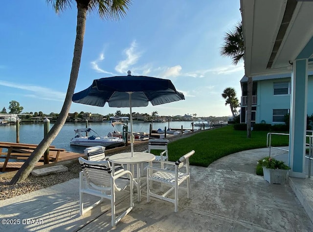 325 Causeway Cswy N Unit D104, New Smyrna Beach, FL 32169 - view of patio with a water view and a boat dock