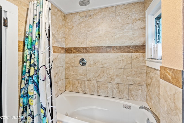 bathroom with tile walls and shower / bath combo with shower curtain