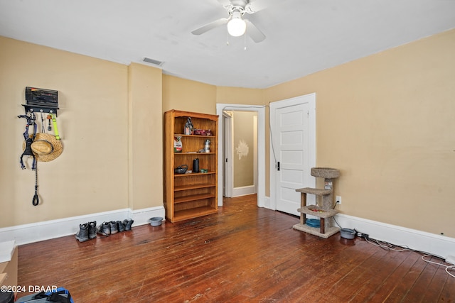 interior space with dark wood-type flooring and ceiling fan