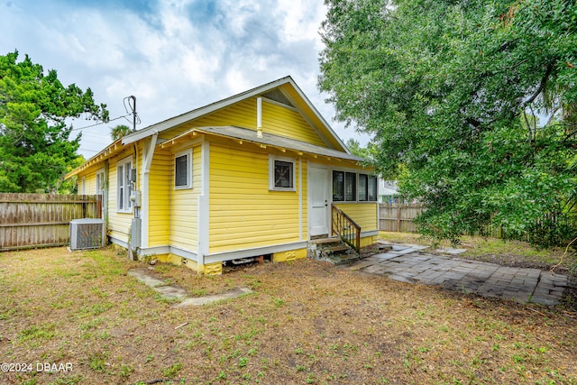 rear view of house with cooling unit