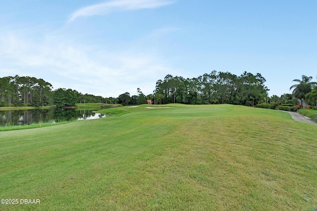 1329 Sunningdale Ln, Ormond Beach, FL 32174 - view of community featuring a water view, view of golf course, view of scattered trees, and a yard