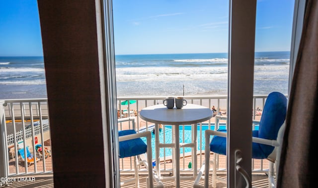 balcony with a beach view and a water view