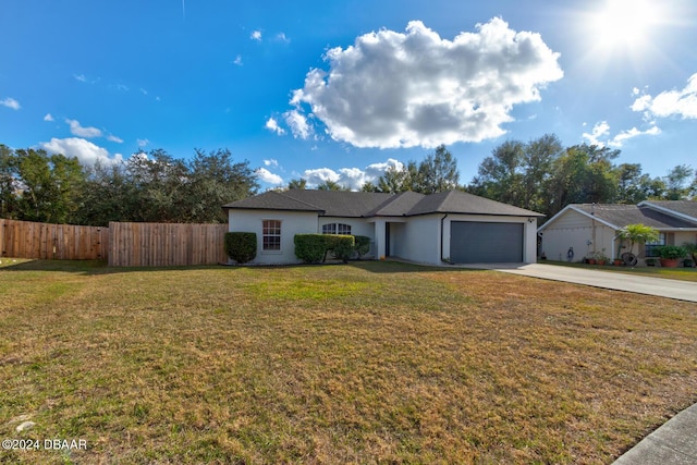 single story home featuring a garage and a front yard