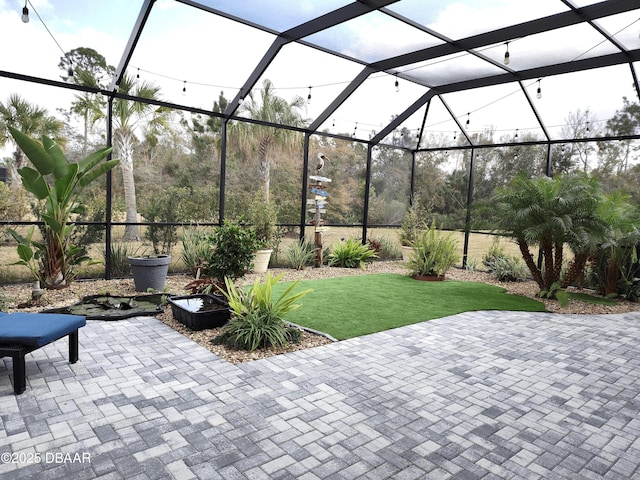 view of patio / terrace featuring a lanai