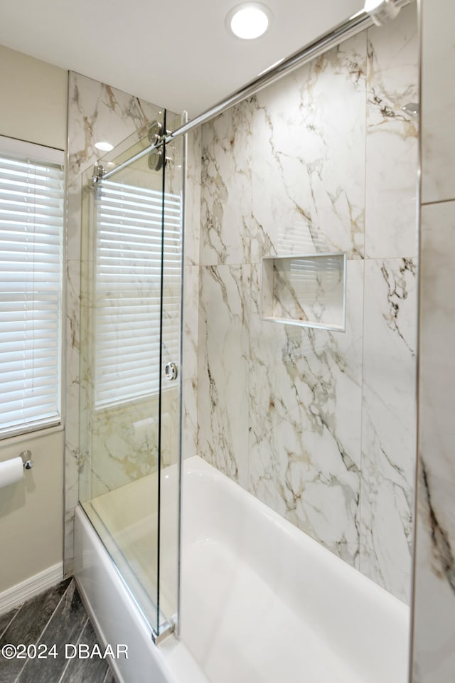 bathroom featuring shower / bath combination with glass door