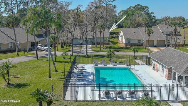 view of swimming pool with a lawn and a patio