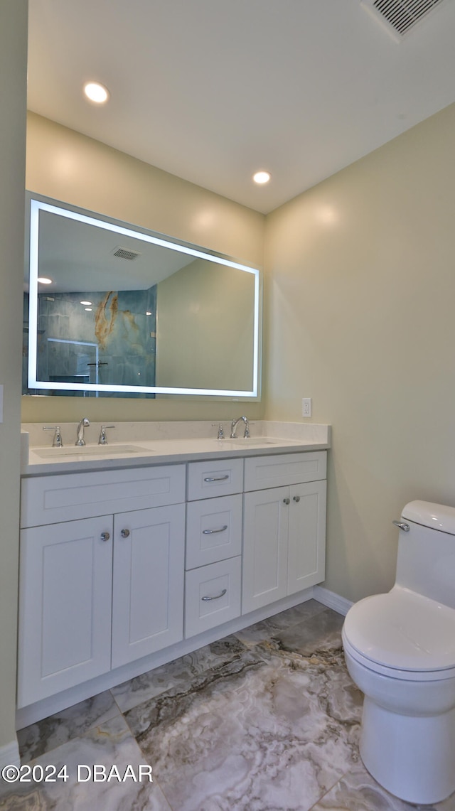 bathroom featuring vanity and toilet