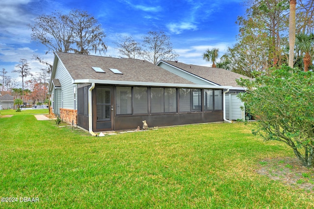 back of house with a sunroom and a yard