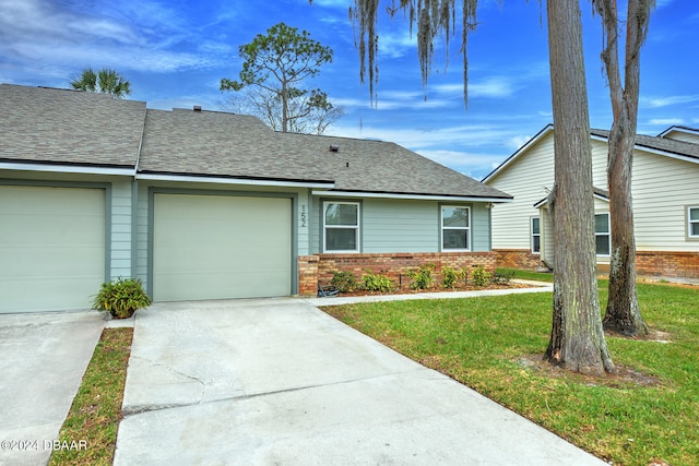 view of front of house featuring a garage and a front lawn