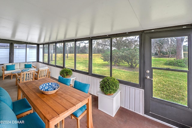 sunroom with a wealth of natural light and lofted ceiling