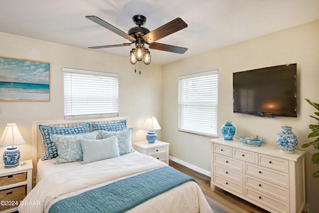 bedroom with dark wood-type flooring and ceiling fan