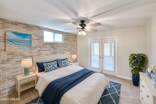 bedroom featuring brick wall, ceiling fan, light colored carpet, french doors, and access to outside