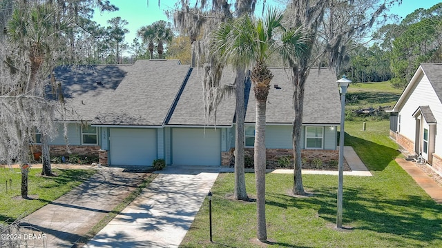 view of front of property with a garage and a front yard