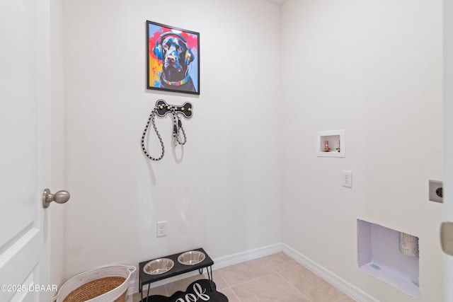 clothes washing area with light tile patterned floors, hookup for a washing machine, and electric dryer hookup