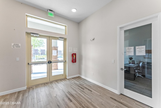 entryway with french doors and light wood-type flooring