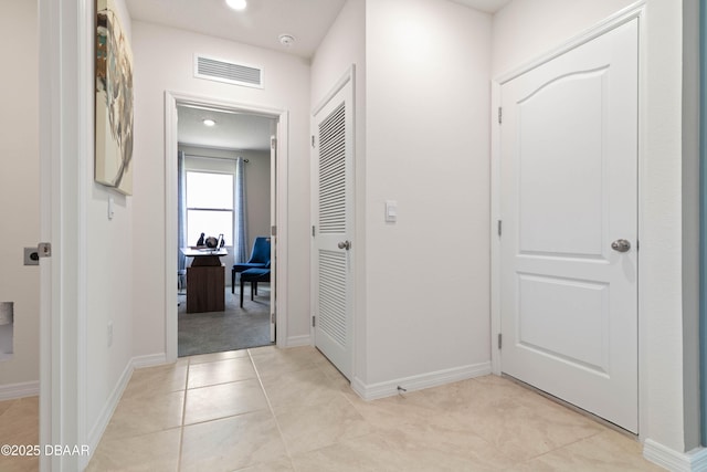 hallway with light tile patterned floors