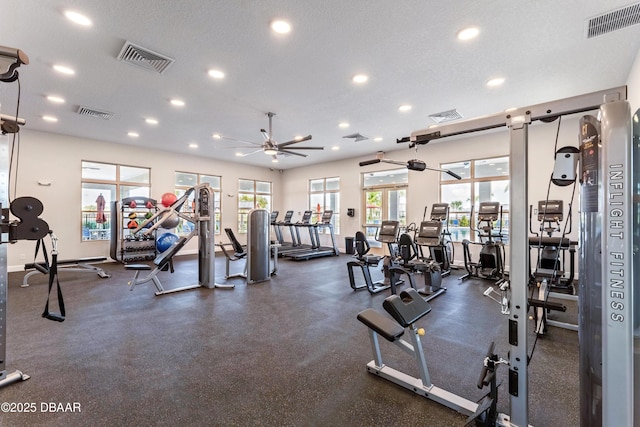 workout area featuring a textured ceiling and ceiling fan