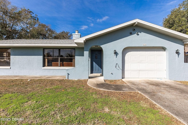 single story home featuring a garage and a front lawn