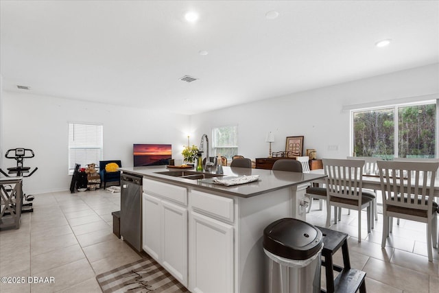 1223 Cabot Cliffs Dr, Daytona Beach, FL 32124 - kitchen featuring light tile patterned floors, visible vents, a kitchen island with sink, a sink, and dishwasher