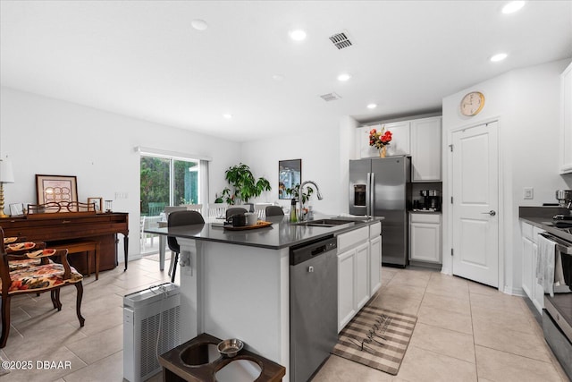 1223 Cabot Cliffs Dr, Daytona Beach, FL 32124 - kitchen with a sink, dark countertops, a kitchen island with sink, and stainless steel appliances