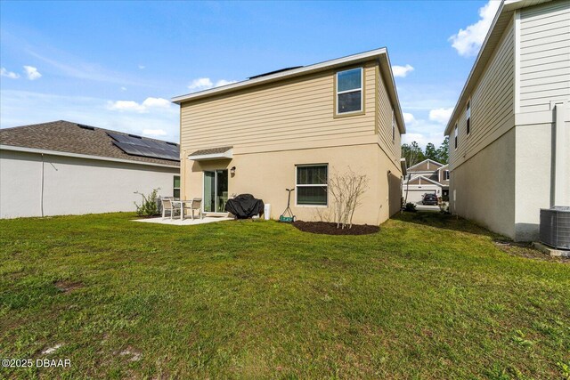 1223 Cabot Cliffs Dr, Daytona Beach, FL 32124 - back of property featuring a yard, central air condition unit, stucco siding, and a patio