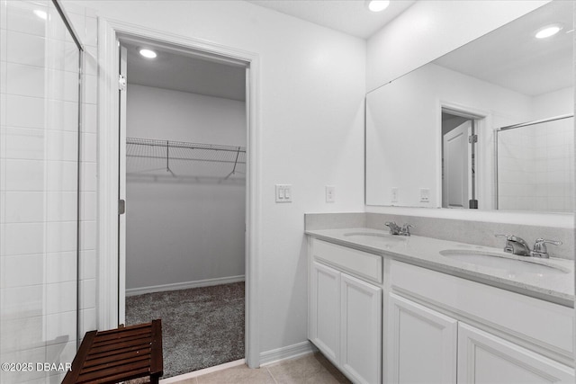 1223 Cabot Cliffs Dr, Daytona Beach, FL 32124 - full bath featuring a sink, double vanity, a spacious closet, and a tile shower