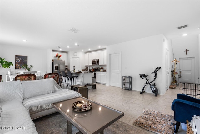 1223 Cabot Cliffs Dr, Daytona Beach, FL 32124 - living area featuring light tile patterned floors, visible vents, recessed lighting, and baseboards