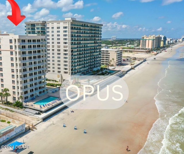 aerial view with a water view and a view of the beach