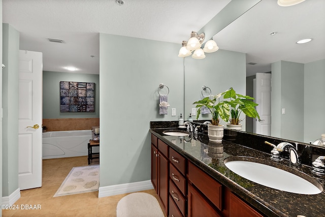 bathroom featuring tile patterned flooring, vanity, and a bathing tub