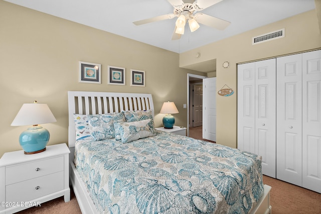 carpeted bedroom with ceiling fan and a closet