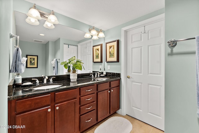 bathroom with tile patterned floors and vanity