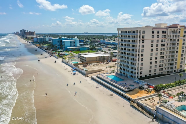 bird's eye view featuring a view of the beach and a water view