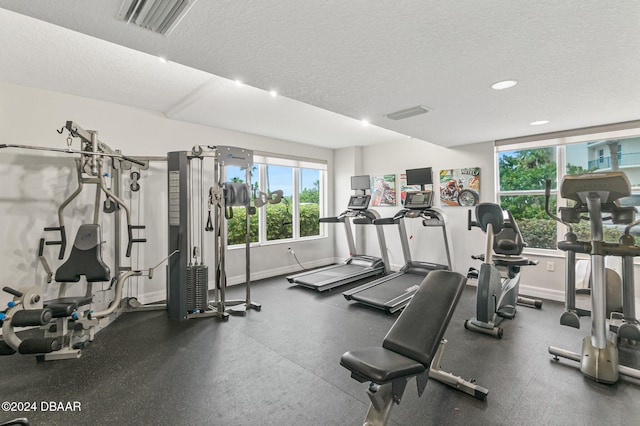 workout area with a textured ceiling