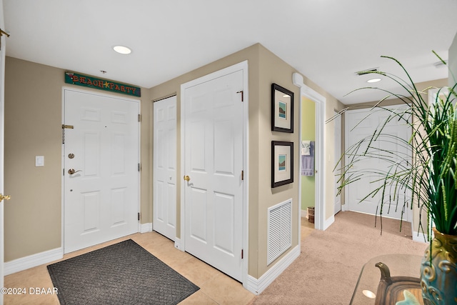 foyer entrance with light tile patterned floors