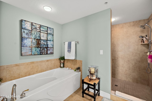 bathroom with shower with separate bathtub and a textured ceiling