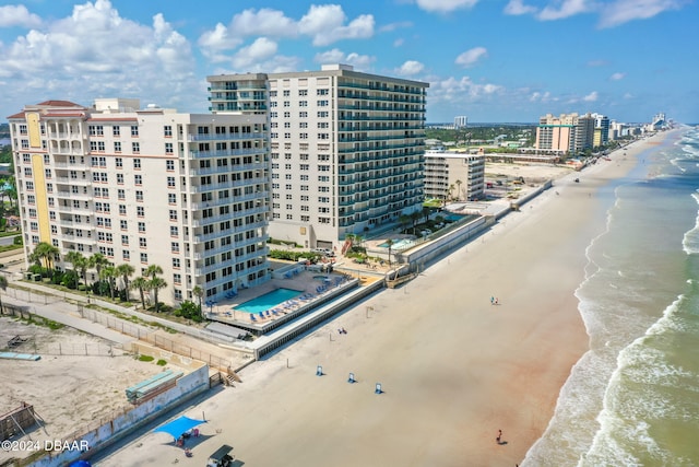 drone / aerial view featuring a water view and a view of the beach