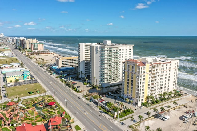 birds eye view of property featuring a water view and a view of the beach