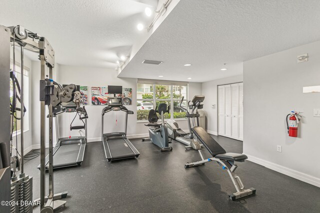 exercise room featuring a textured ceiling