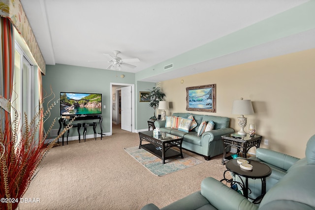 carpeted living room with ceiling fan