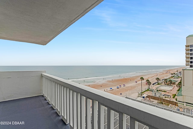 balcony with a water view and a beach view