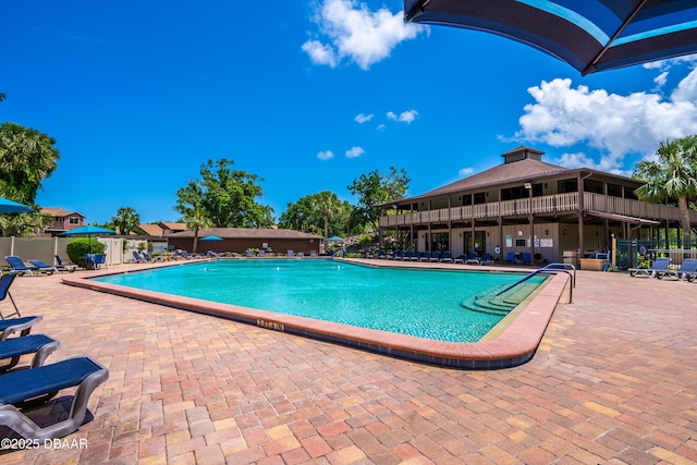 pool featuring a patio and fence